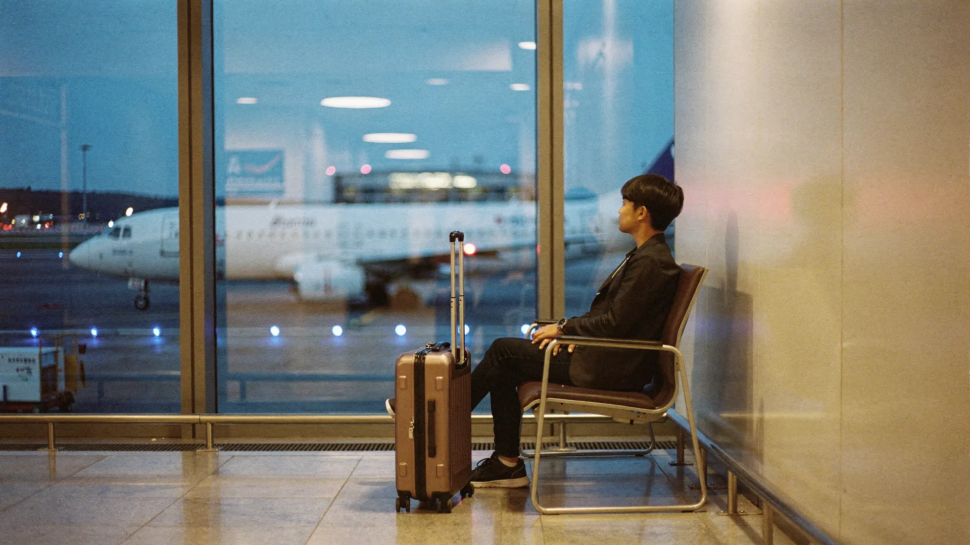 A traveler with a carry-on bag at the airport